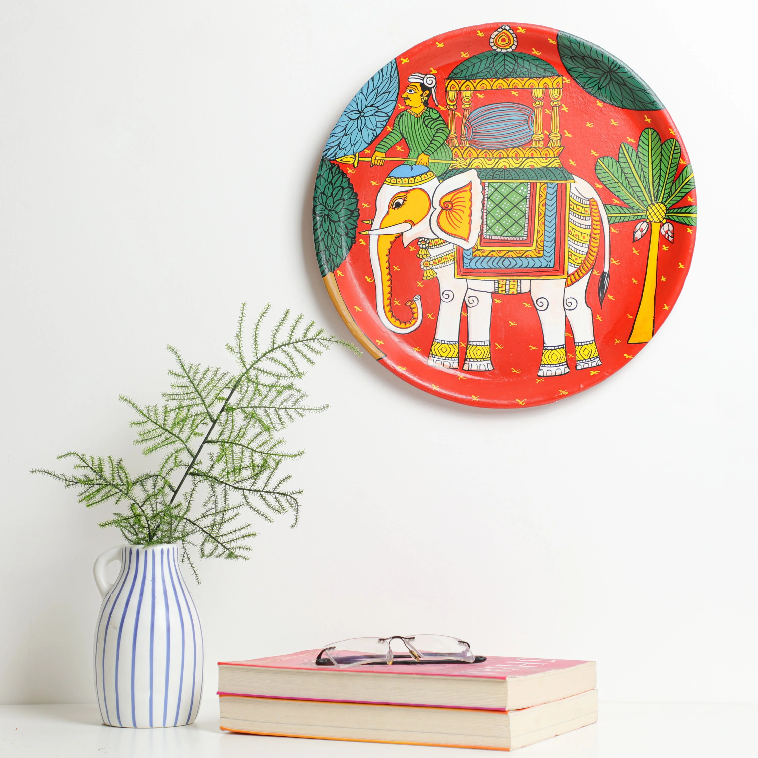 Material: This vibrant cheriyal wall plate &nbsp;is hand-painted using natural colours on a canvas, stretched over a plate