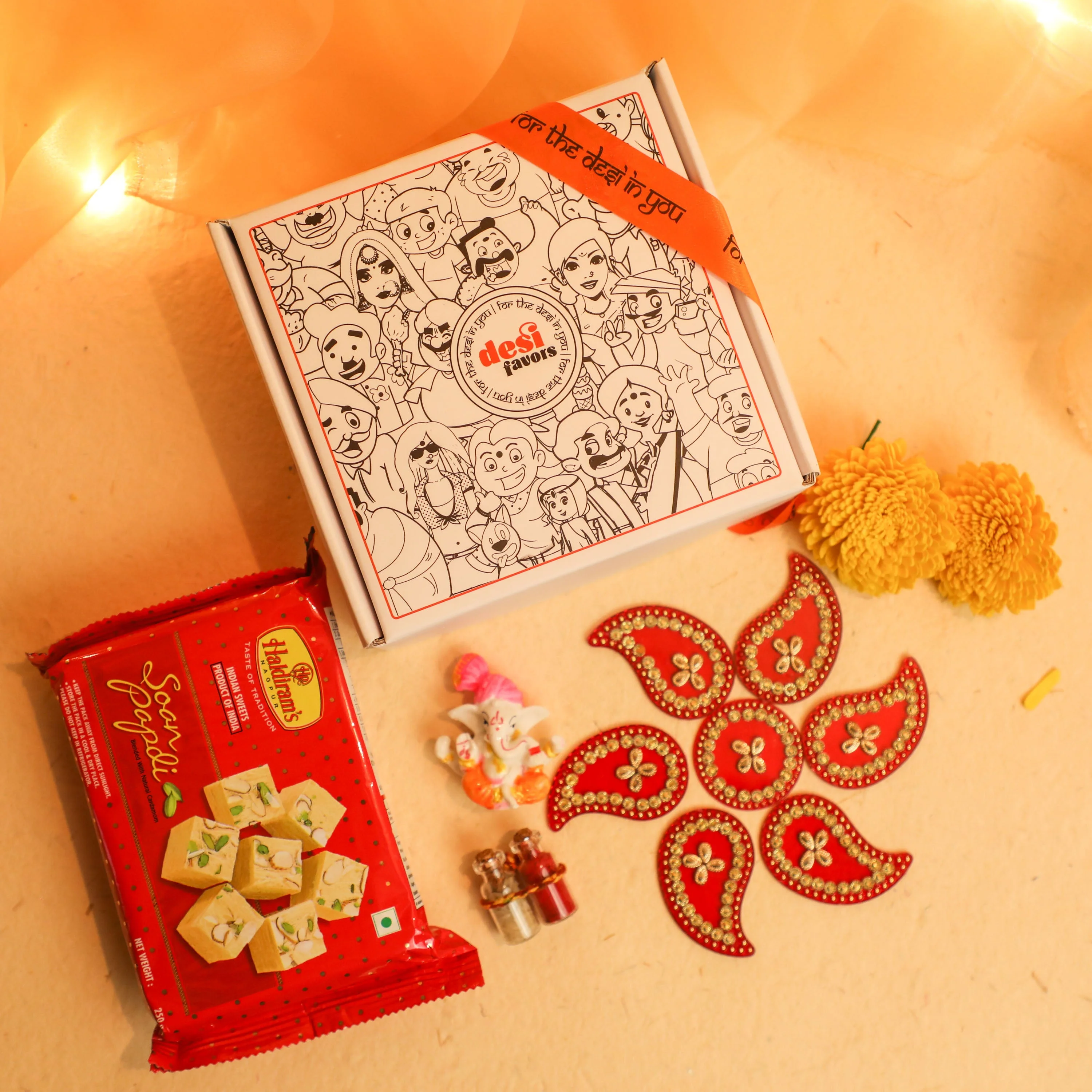 Rangoli Set + Ganesha Idol + &nbsp;Shola Flowers + Roli Chawal + Soan Papdi box