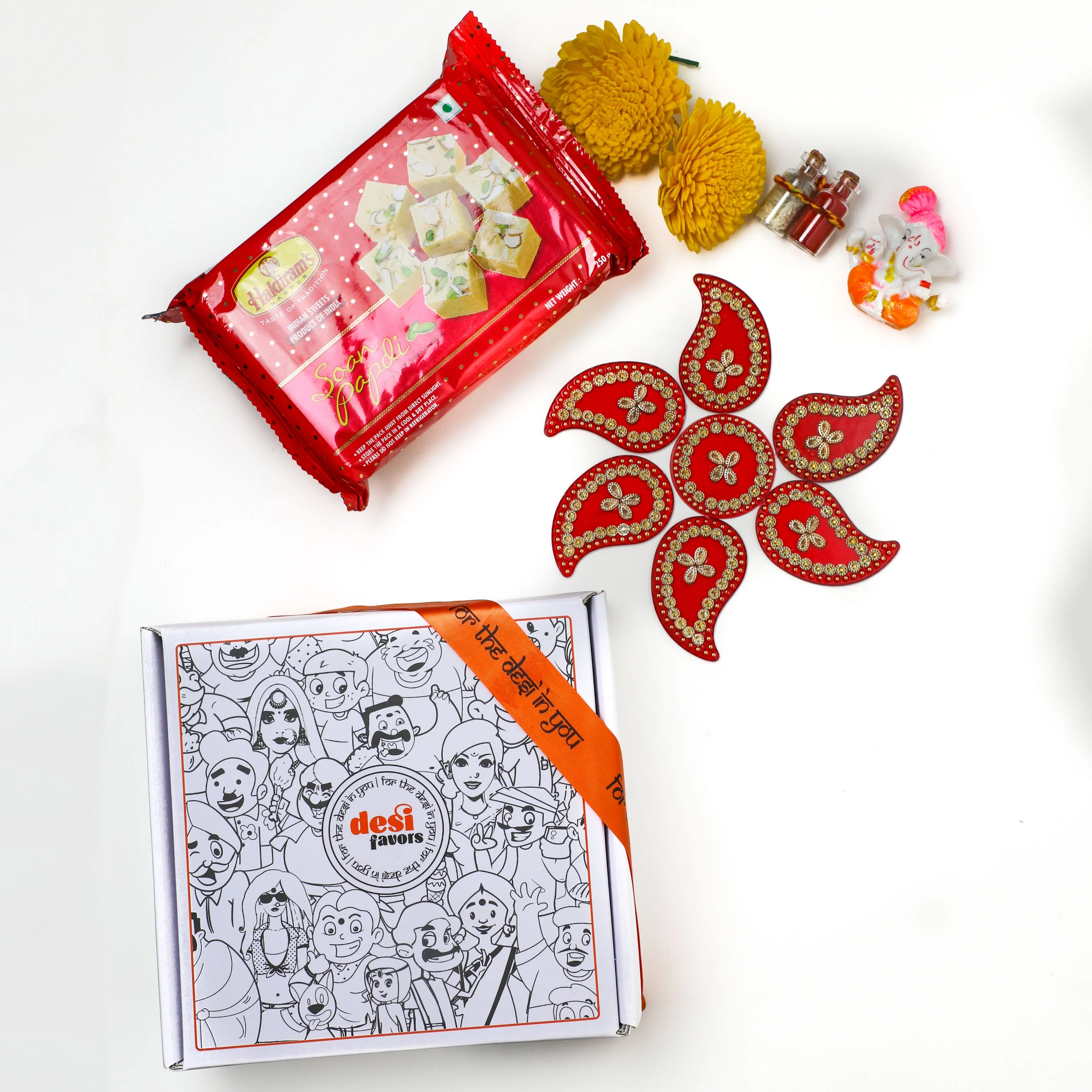 Rangoli Set + Ganesha Idol + &nbsp;Shola Flowers + Roli Chawal + Soan Papdi box