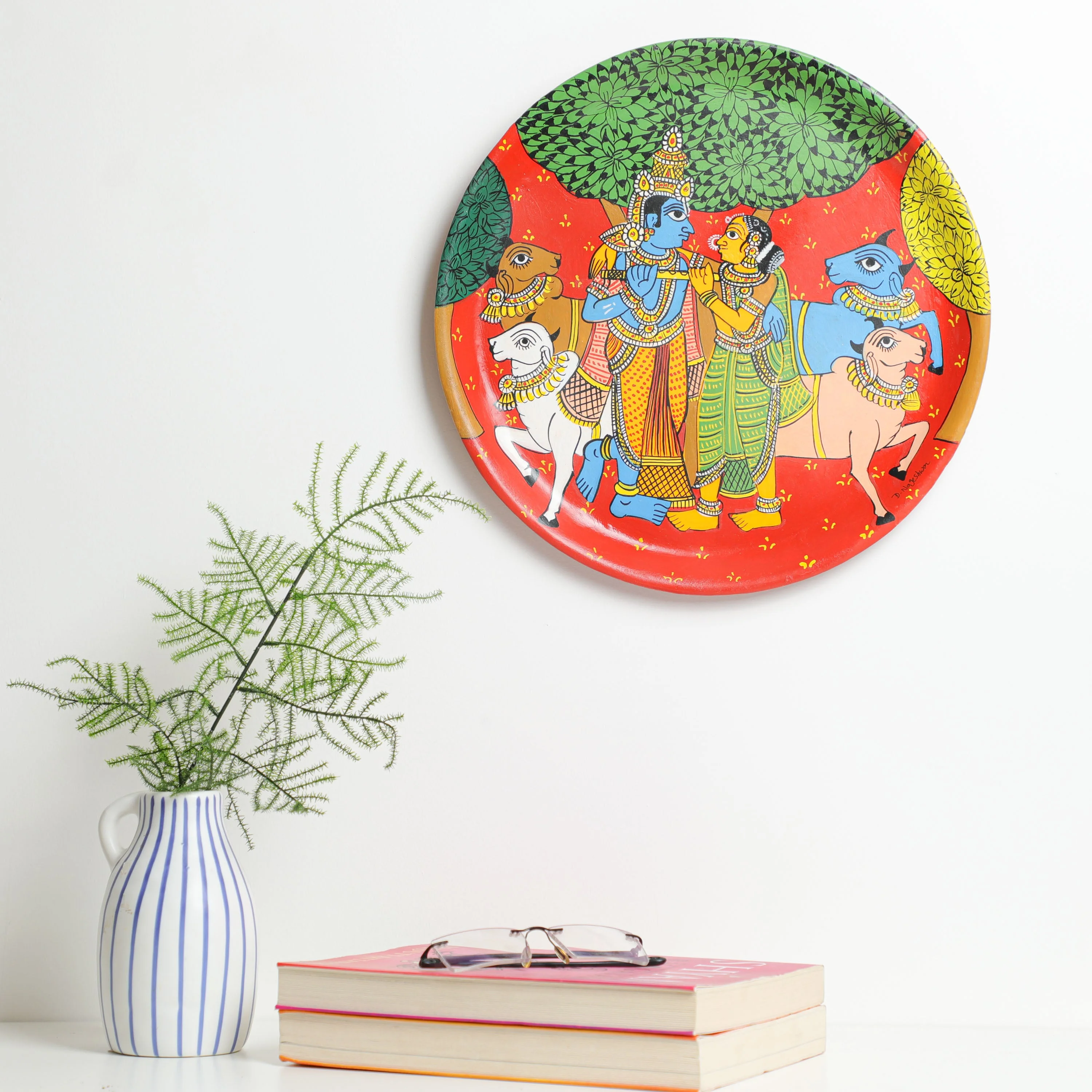 Material: This vibrant cheriyal wall plate &nbsp;is hand-painted using natural colours on a canvas, stretched over a plate