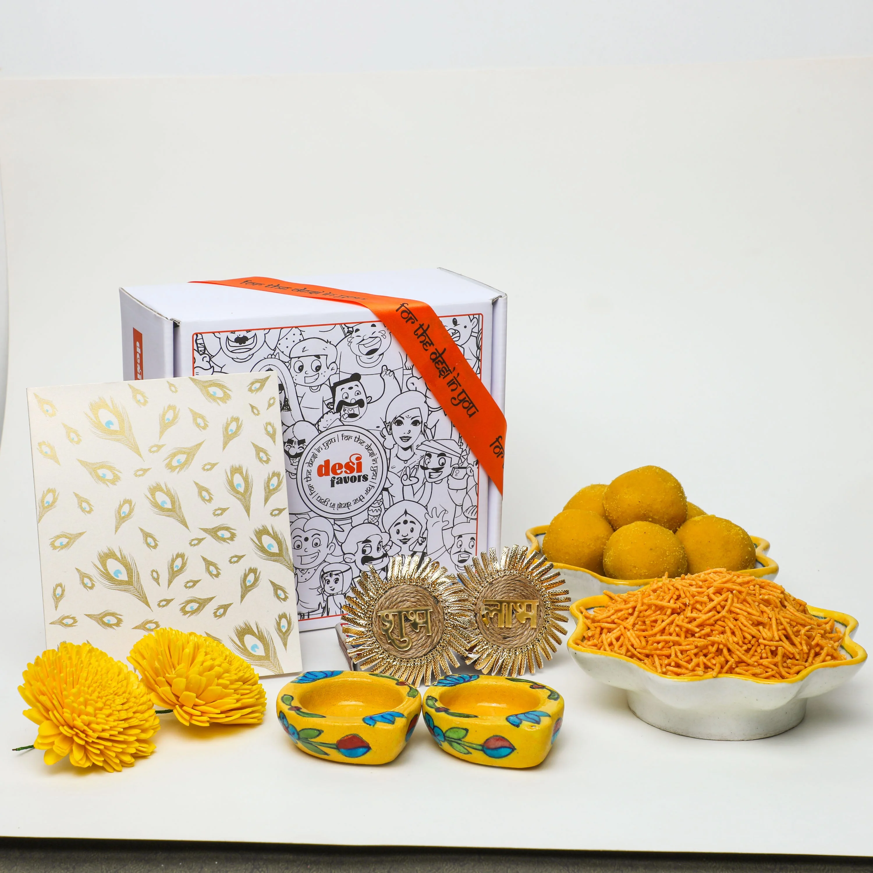 2 Blue Lotus painted Tealight holders + 250gm Besan Laddu + 250gm Namkeen + &nbsp;Shubh Labh Stick ups + Diwali Greeting