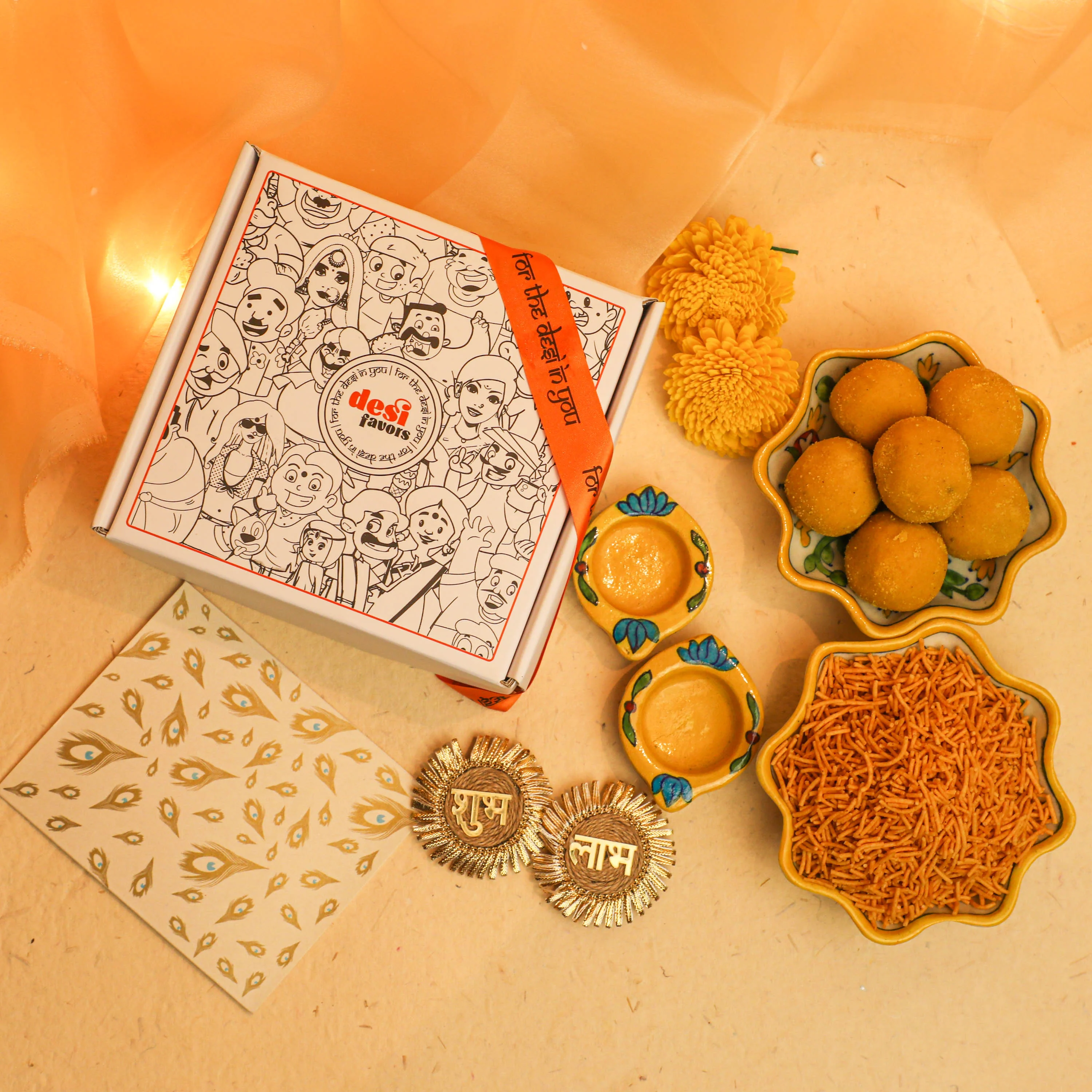 2 Blue Lotus painted Tealight holders + 250gm Besan Laddu + 250gm Namkeen + &nbsp;Shubh Labh Stick ups + Diwali Greeting