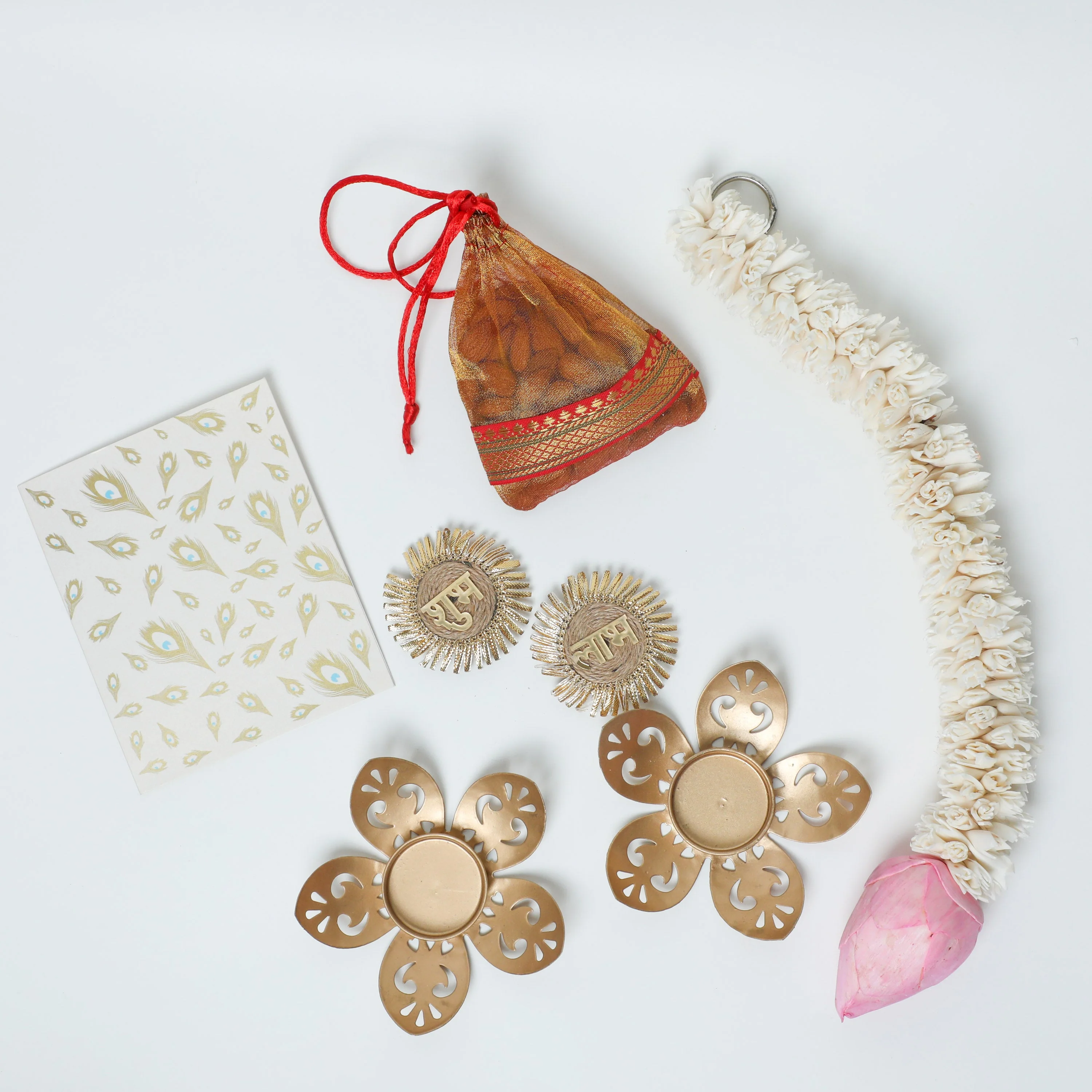 2 Metal diyas + Dry fruits + 1 ft lotus string + Shubh Labh stickers + Dry fruits + Diwali Card